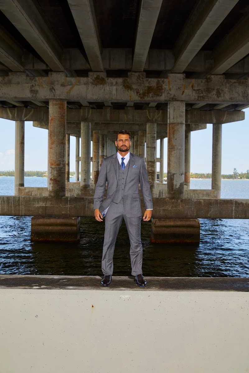 A groom wearing a grey three piece wedding suit that balances the shoulders, waist, and overall silhouette.
