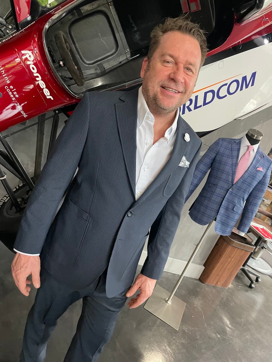 Man wearing a well-tailored beige suit styled for a warm-weather Miami occasion