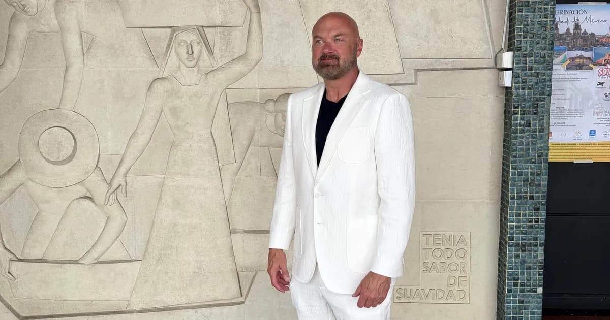 Man wearing a white seersucker suit with black t-shirt at a Miami event, styled by Bespoke By CB