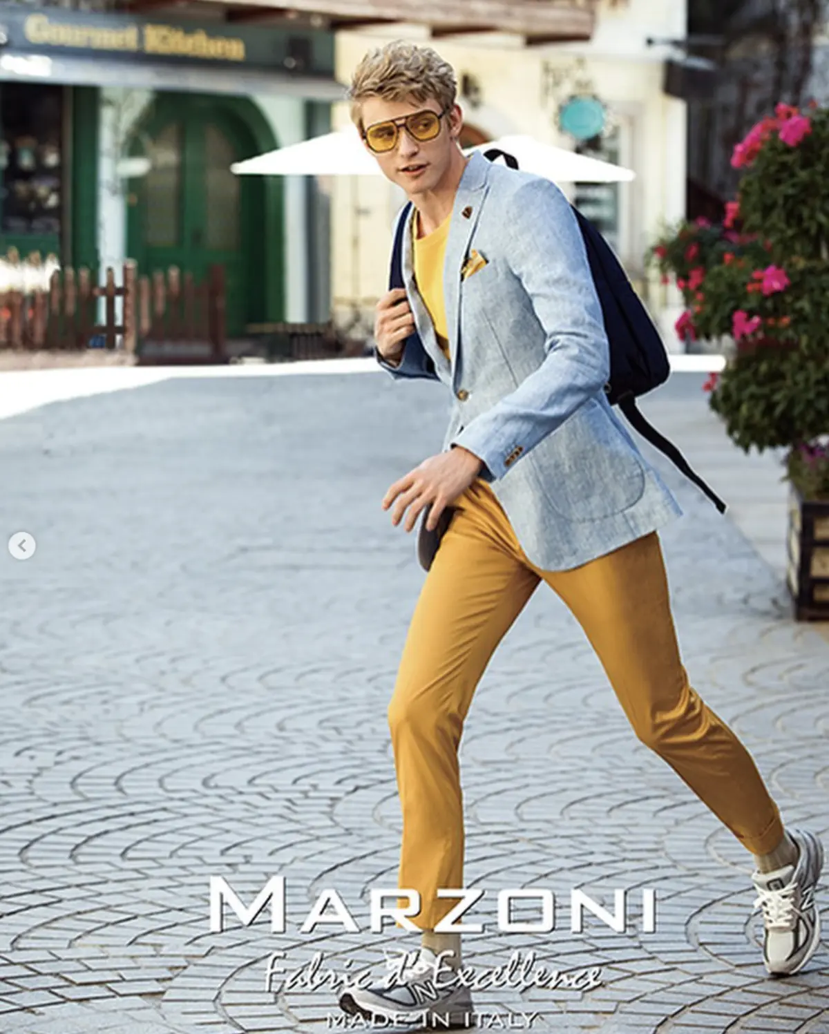 Marzoni chambray linen blazer with mustard trousers in European town square — summer fabric