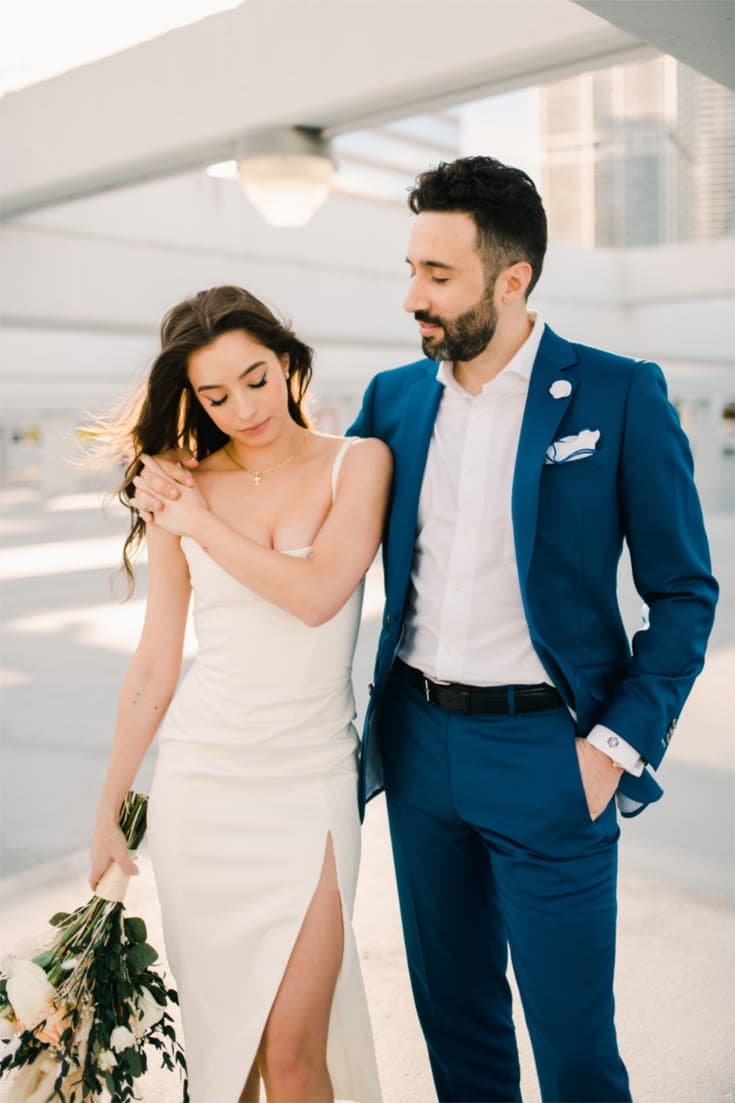 Bride and groom in custom wedding attire by Bespoke By CB
