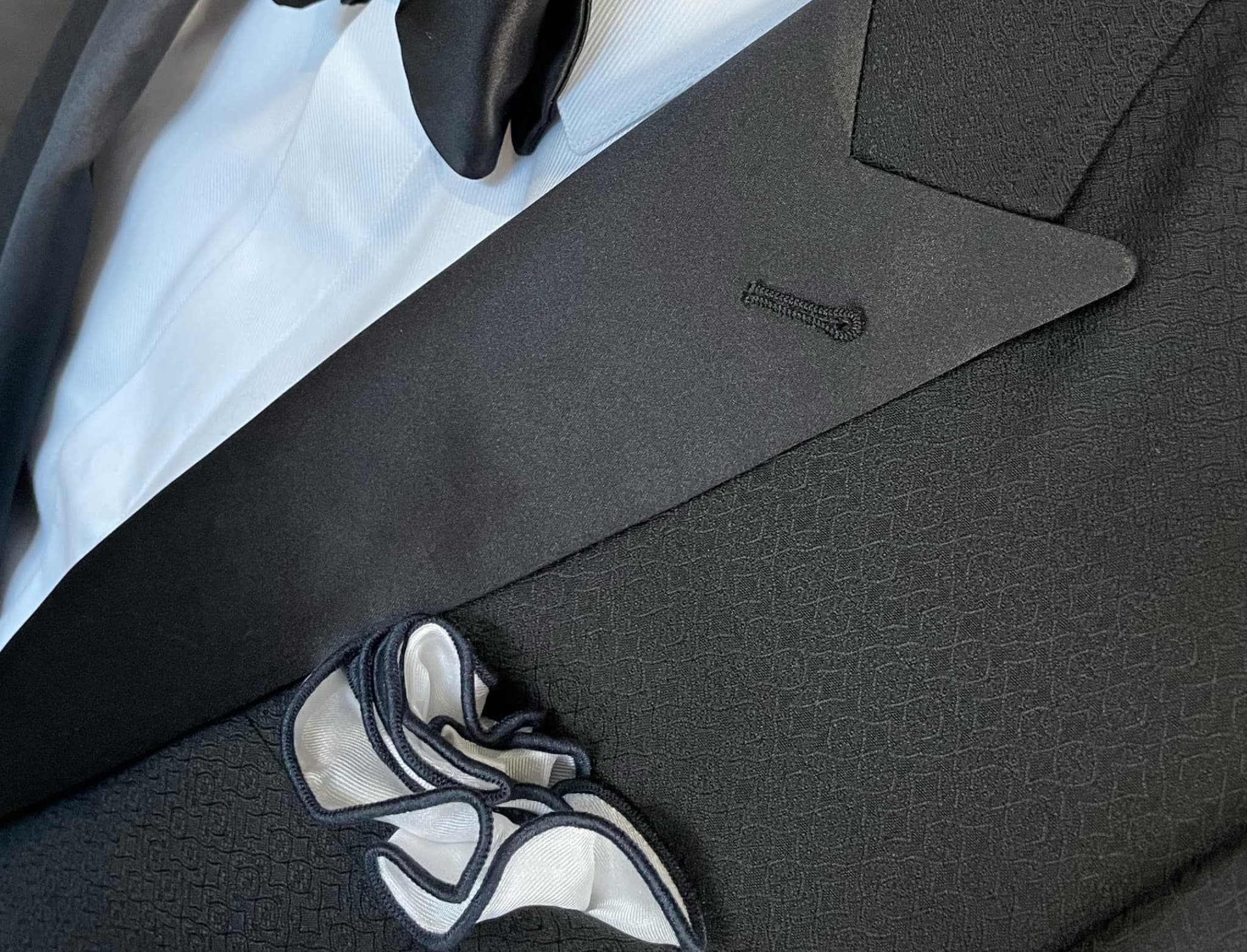 Premium fabric selection at Bespoke By CB Miami — Scabal, Dormeuil, and Loro Piana swatches