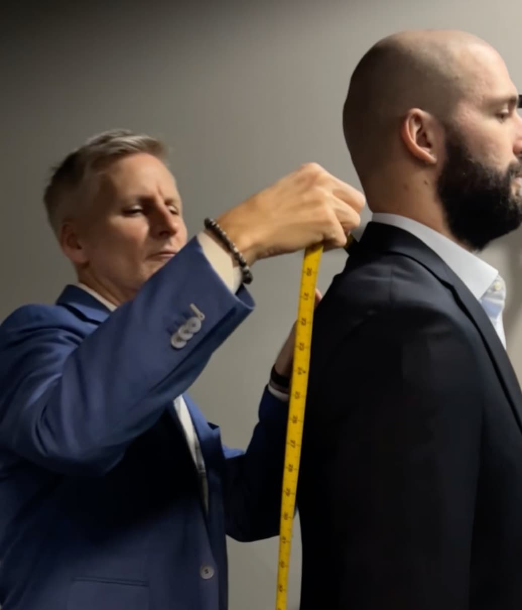 Christian Boehm taking precise body measurements for a custom suit at Bespoke By CB Miami