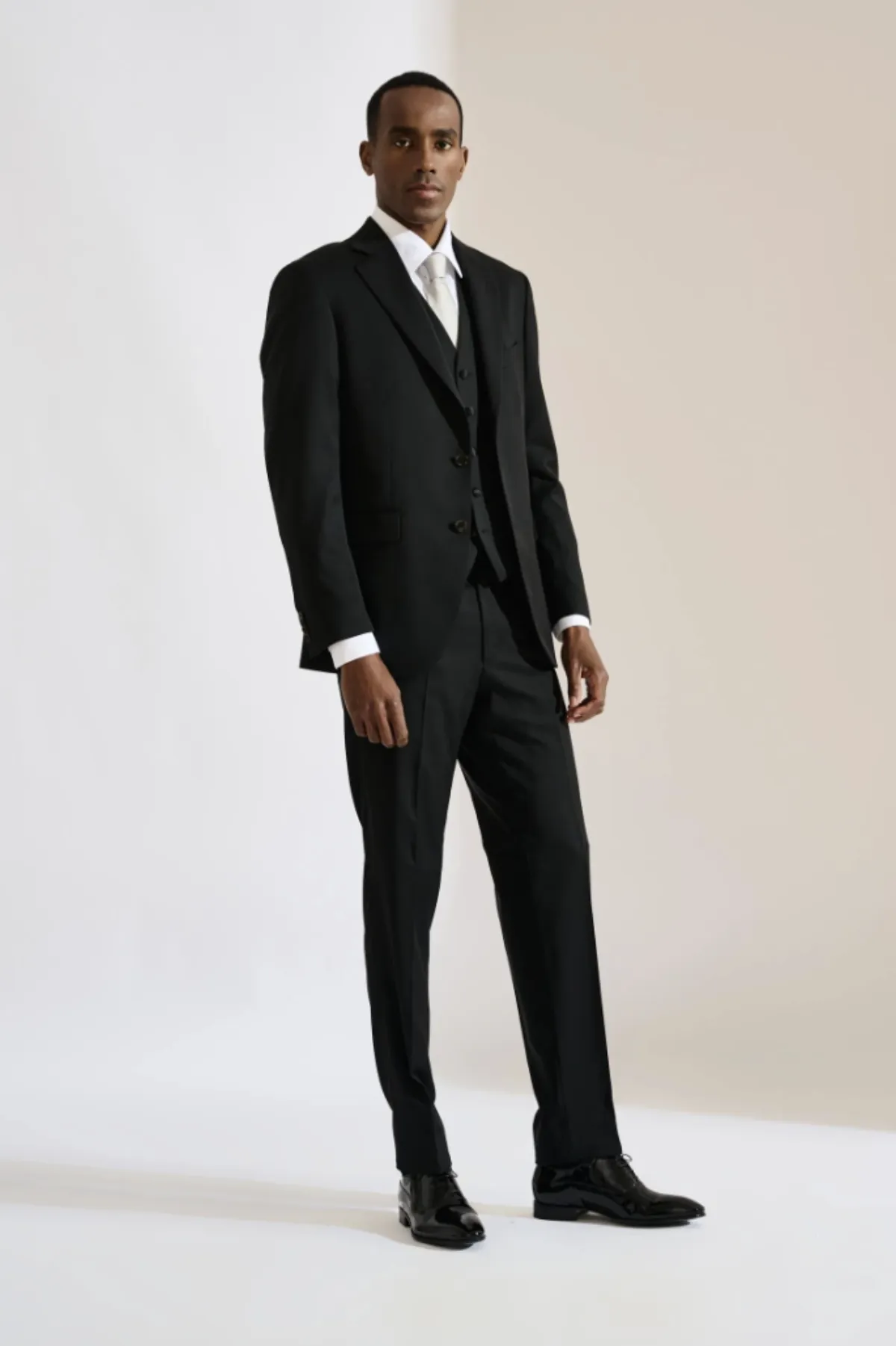 Man wearing a black custom suit styled by Bespoke By CB South Florida