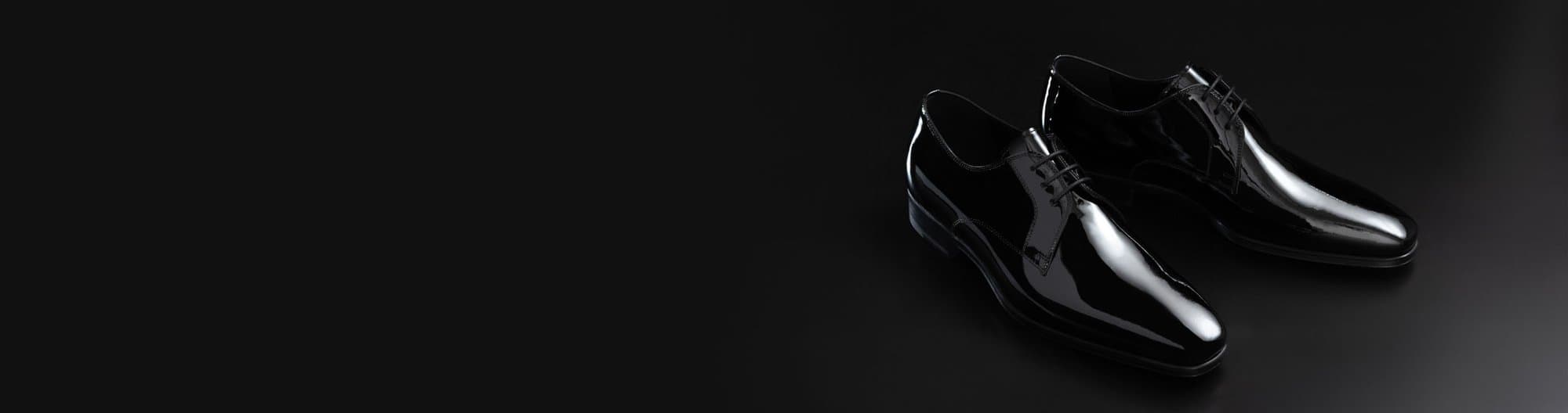 Close-up of formal tuxedo shoes paired with a custom black tuxedo
