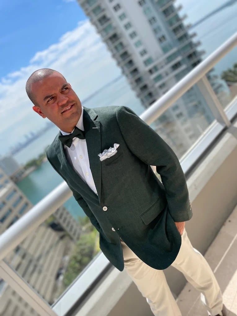Dark green custom suit styled with confidence for Miami events by Bespoke CB — a power color for the man who knows what he's doing