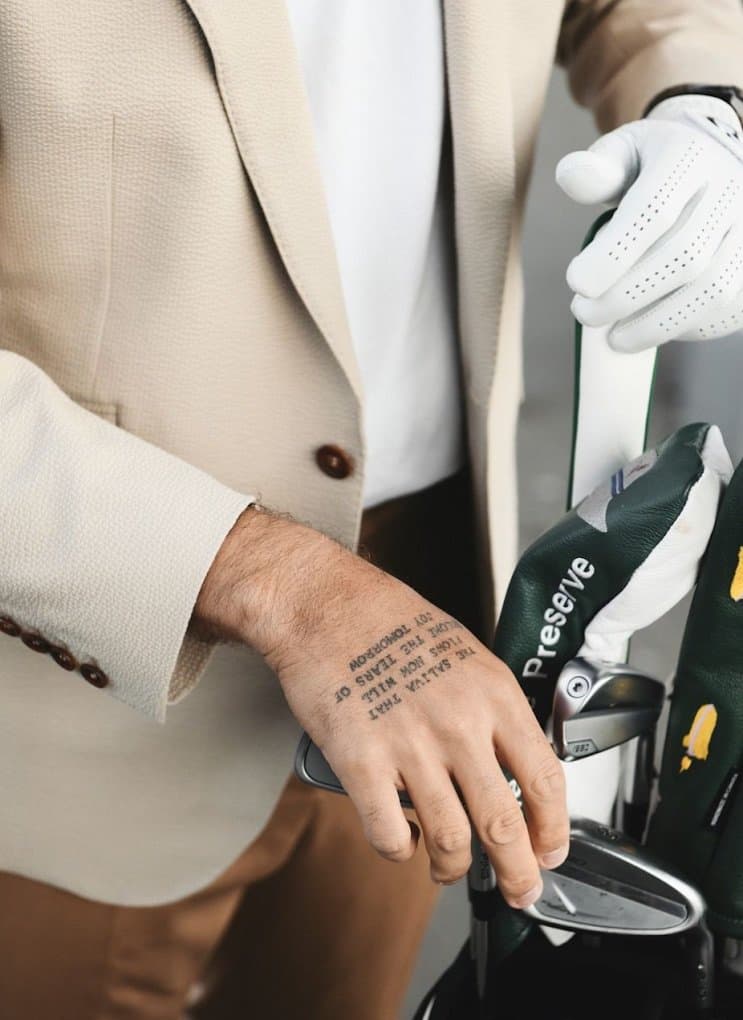 Man in a stylish beige custom suit for a warm-weather event