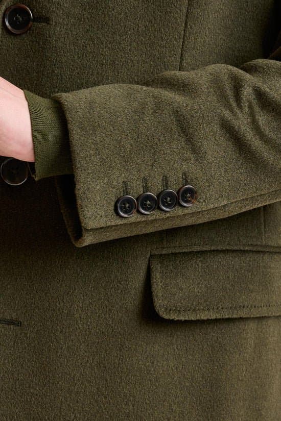 Custom olive green suit jacket close-up showing fabric texture by Bespoke By CB