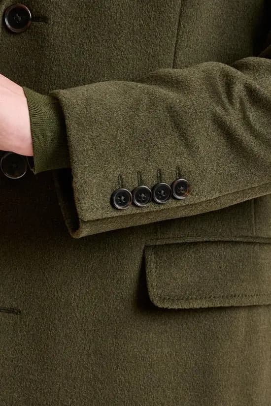 Man wearing an olive green custom suit tailored by Bespoke By CB South Florida