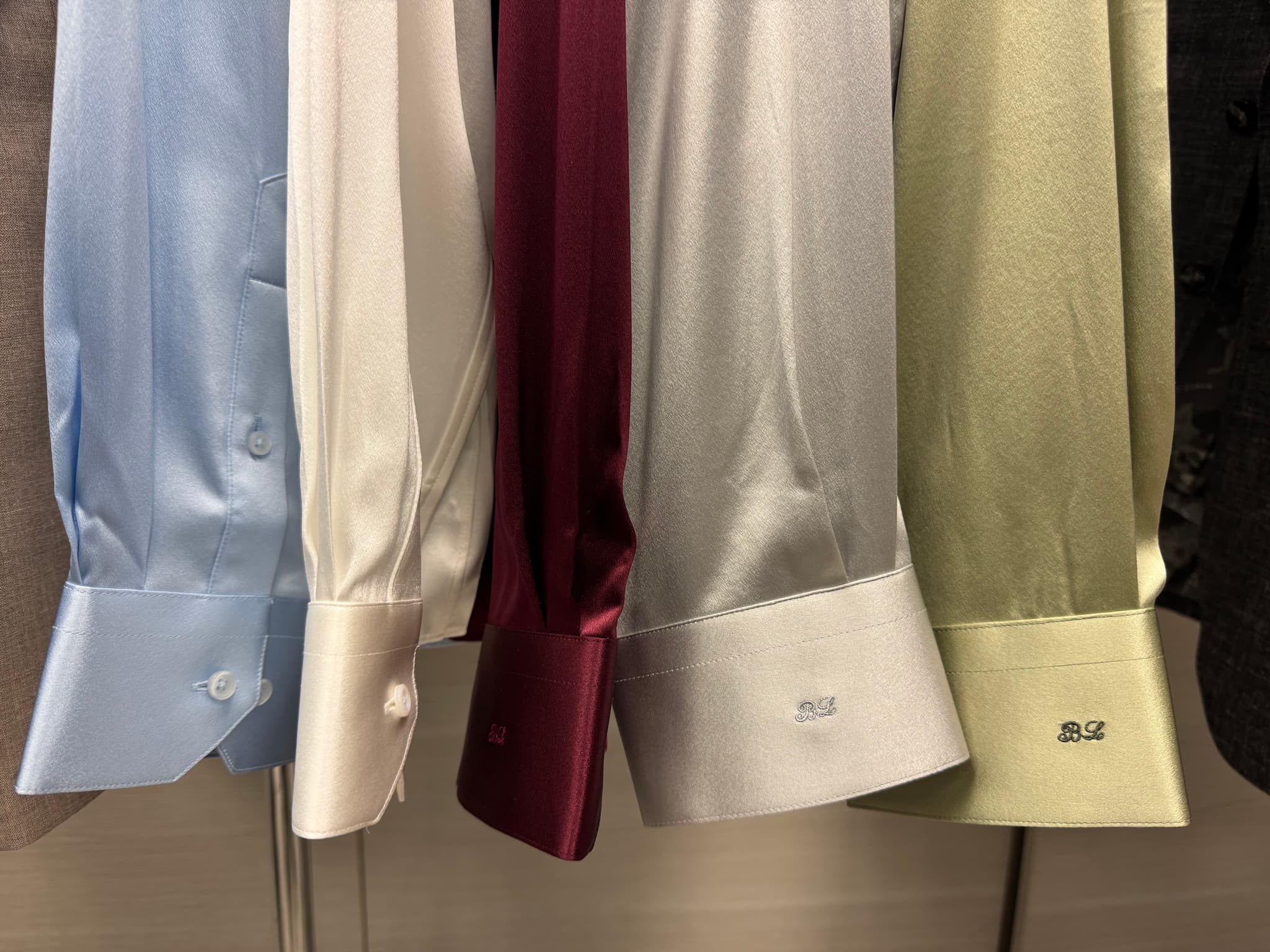 Custom silk shirts in light blue, cream, burgundy, silver, and olive green with BL monogram embroidery by Bespoke By CB