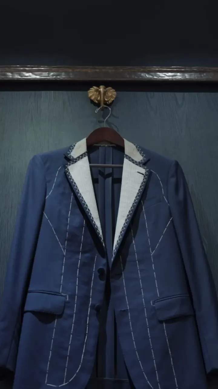 Bespoke suit jacket with white basting stitches — details of bespoke tailoring at Bespoke By CB