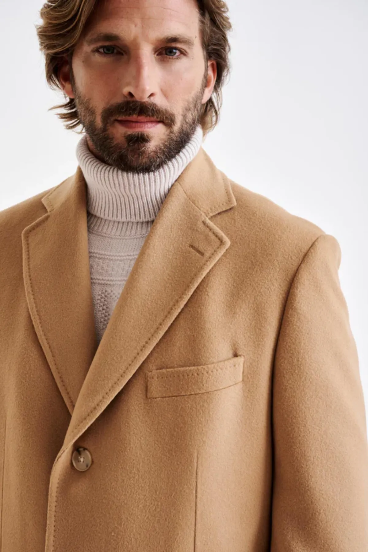 Custom camel overcoat model by Bespoke By CB Miami & Fort Lauderdale — tailored wool coat over turtleneck