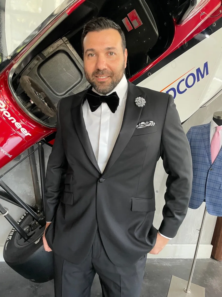 Side-by-side comparison of white dinner jacket and black tuxedo for formal events by Bespoke By CB Miami