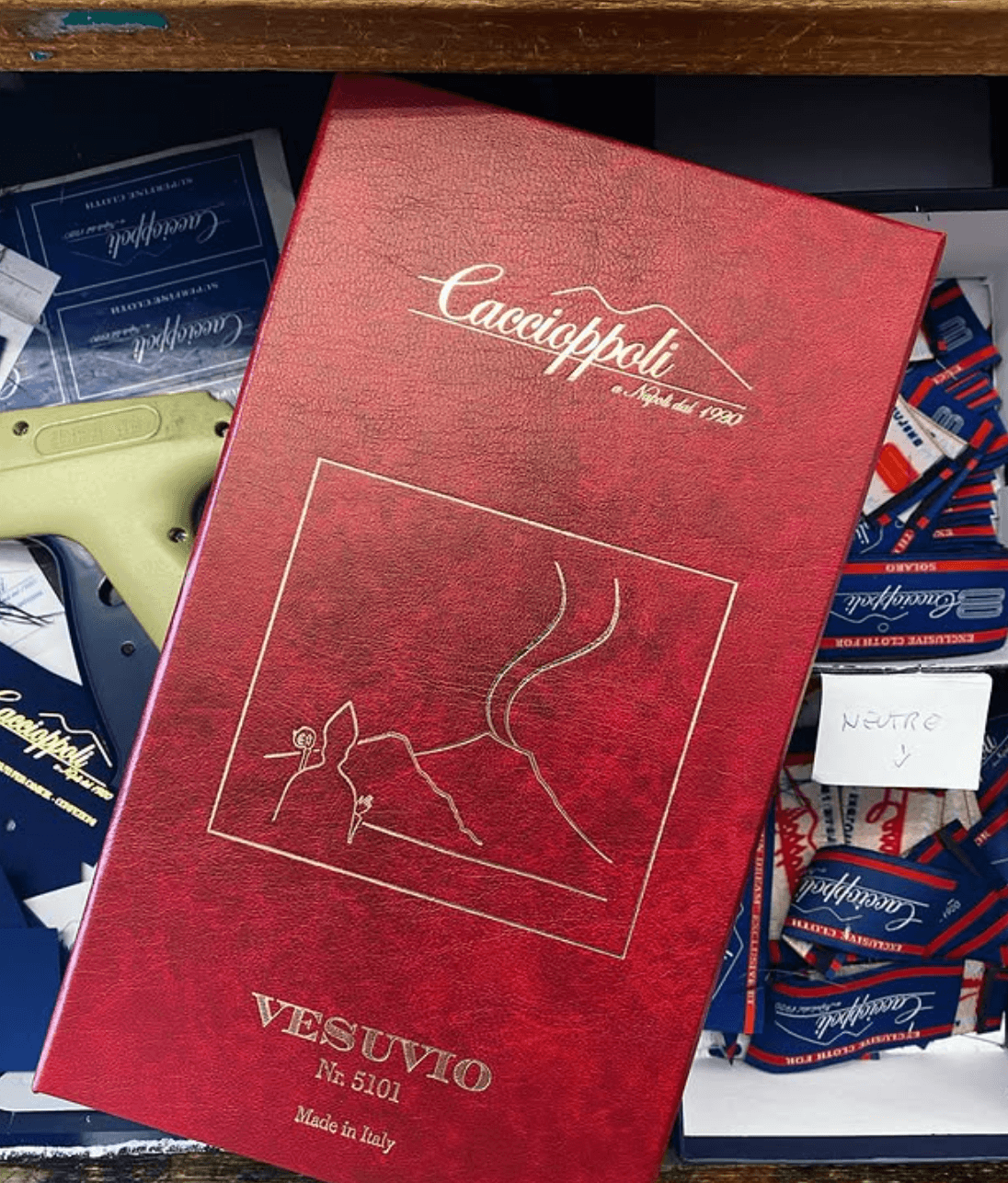 Caccioppoli fabric collection display with Mount Vesuvius logo and rich Neapolitan textiles