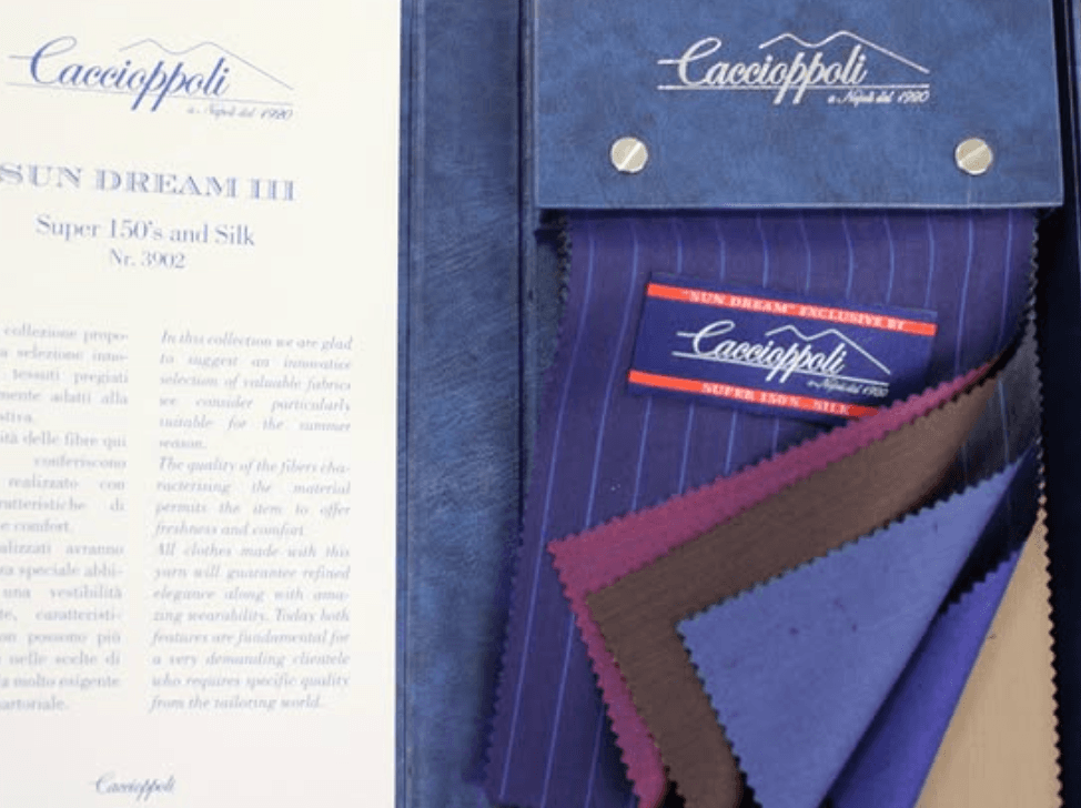 Caccioppoli hanging fabric swatches showing range of patterns from plaids to solids