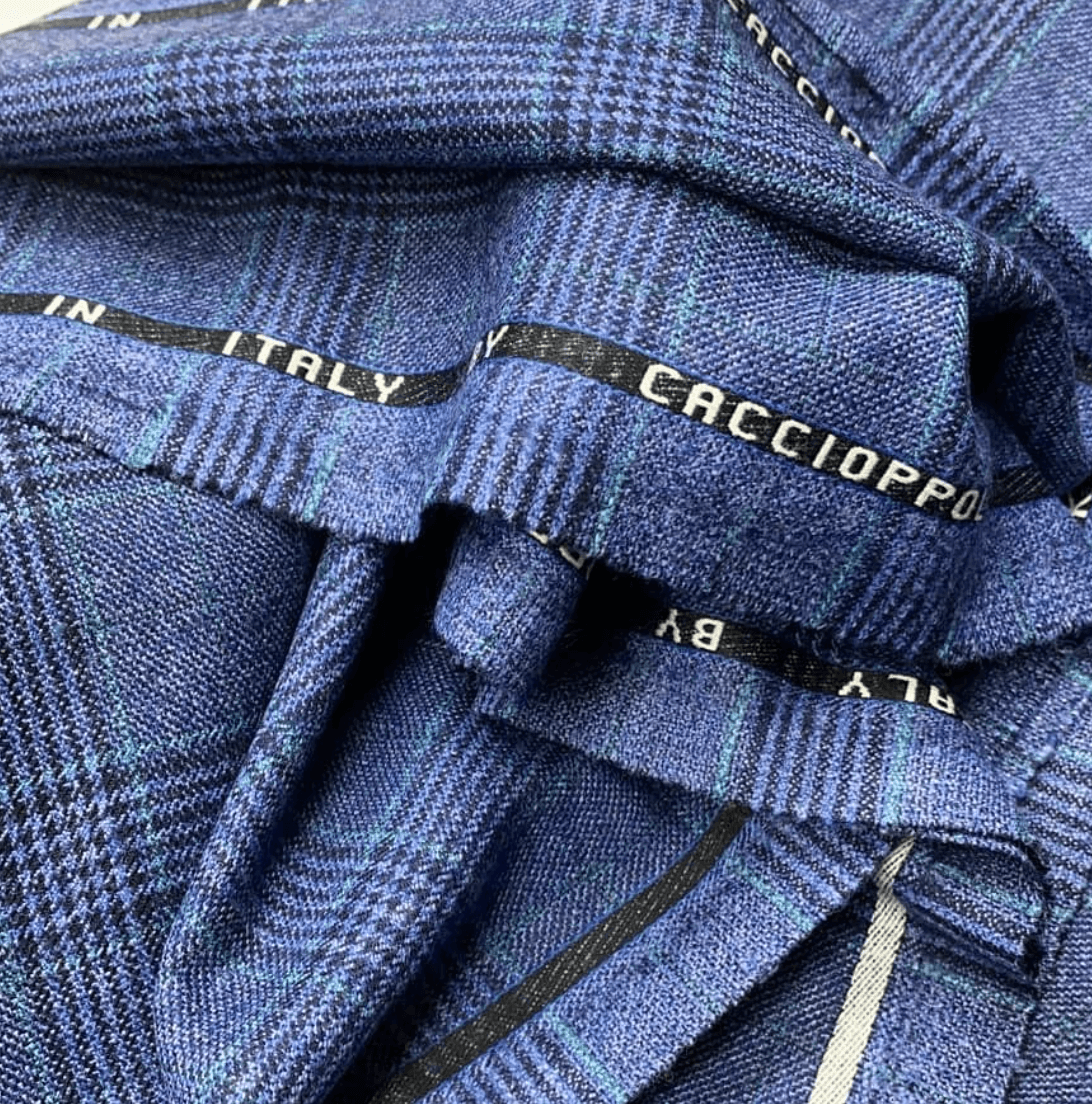 Caccioppoli fabric close-up showing fine weave texture in periwinkle blue