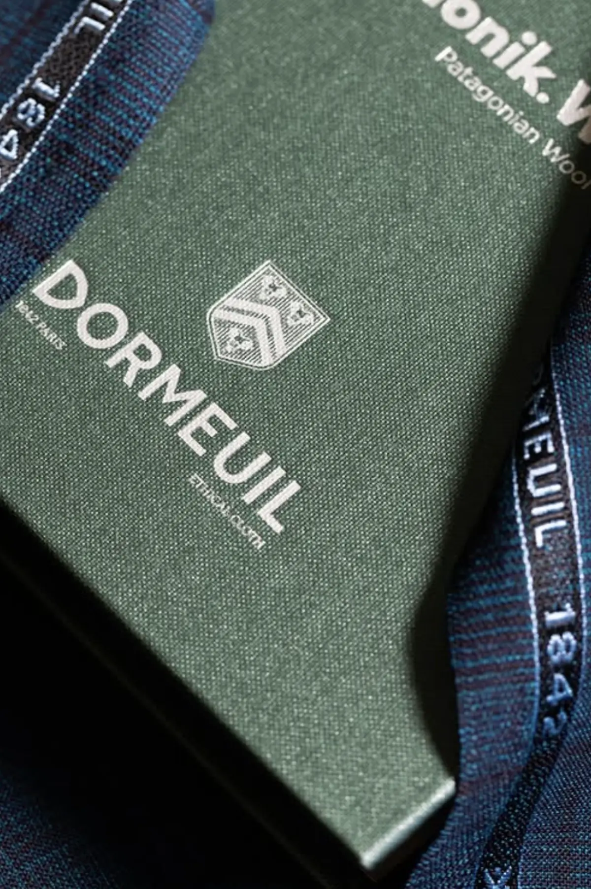 Dormeuil 1842 Ethical Cloth swatch book with selvedge detail on navy wool