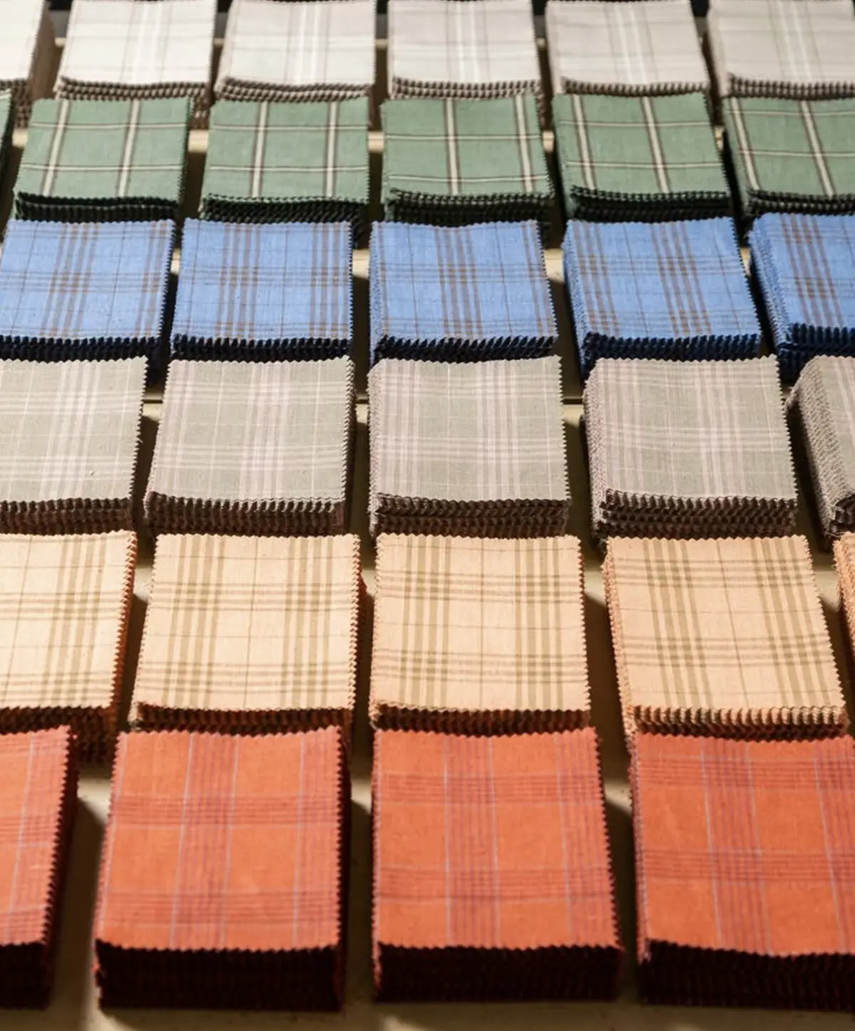Plaid and windowpane check fabric swatches arranged by color family