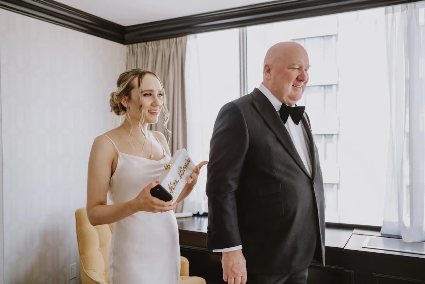 Father of the bride in black tuxedo with bride in white gown getting ready by Bespoke By CB Miami