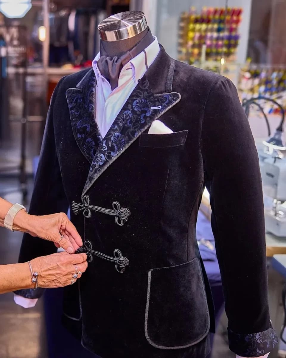 Custom black velvet smoking jacket with brocade lapels and frog closures by Bespoke By CB Miami & Fort Lauderdale