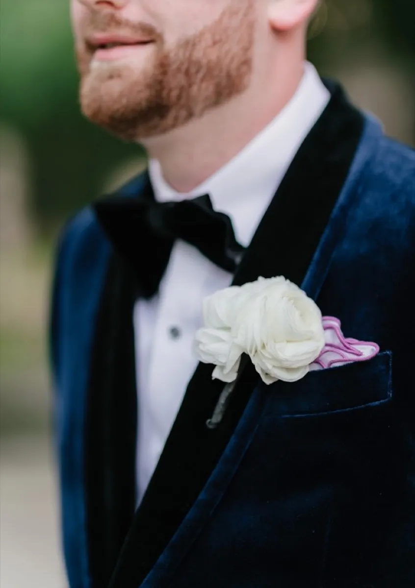 Custom navy velvet tuxedo with shawl lapels and boutonniere by Bespoke By CB Miami & Fort Lauderdale