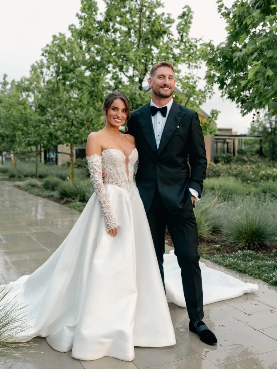 Joey Bosa and Amanda Kassdikian in custom wedding attire, groom in black tuxedo by Bespoke By CB Miami