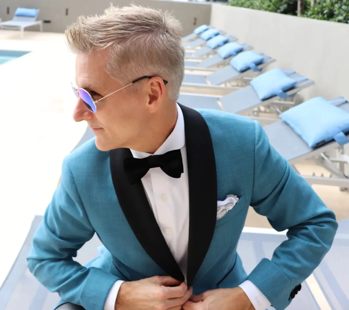 Turquoise tuxedo jacket with black shawl collar by poolside, custom formalwear for Miami